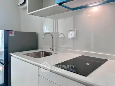 Modern kitchen with sleek countertop and built-in electric stove
