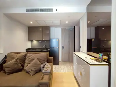 Modern compact living room with integrated kitchen and sleek design.