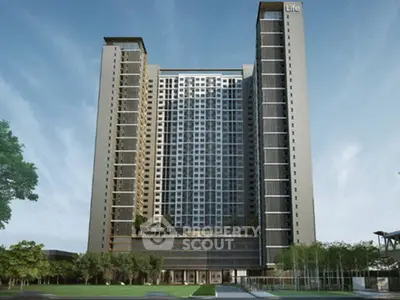 Modern high-rise residential building with sleek design and lush surroundings.