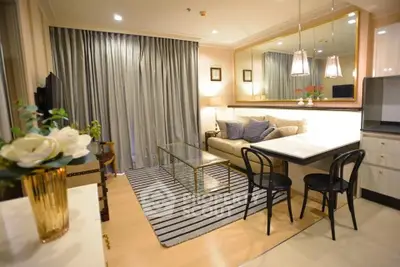 Elegant living room with modern decor, cozy seating, and stylish lighting in a chic apartment.