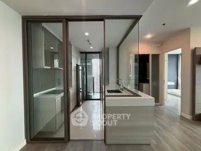 Modern kitchen with sleek glass partitions and stylish cabinetry