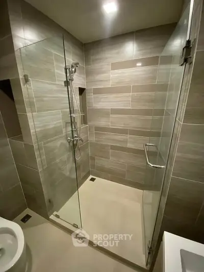 Modern bathroom with glass shower enclosure and sleek tile design