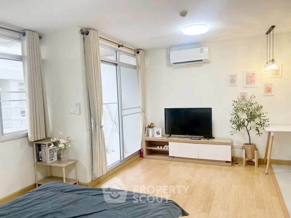 Modern bedroom with balcony access, featuring stylish decor and natural light.