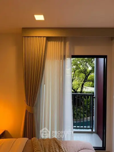 Cozy bedroom with balcony view and elegant curtains