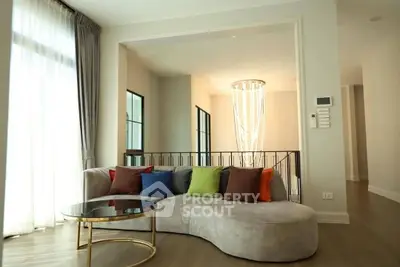 Elegant living room with modern sofa and chic chandelier, perfect for stylish urban living.