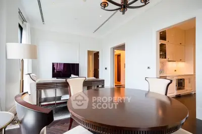 Luxurious living room with elegant dining area and modern kitchen in open layout apartment.