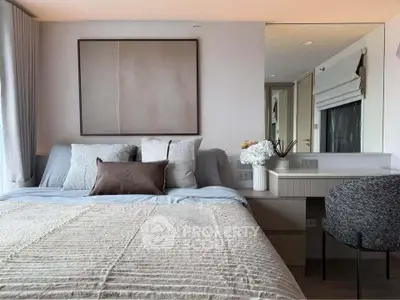 Elegant bedroom with modern decor and cozy bedding in a stylish apartment.