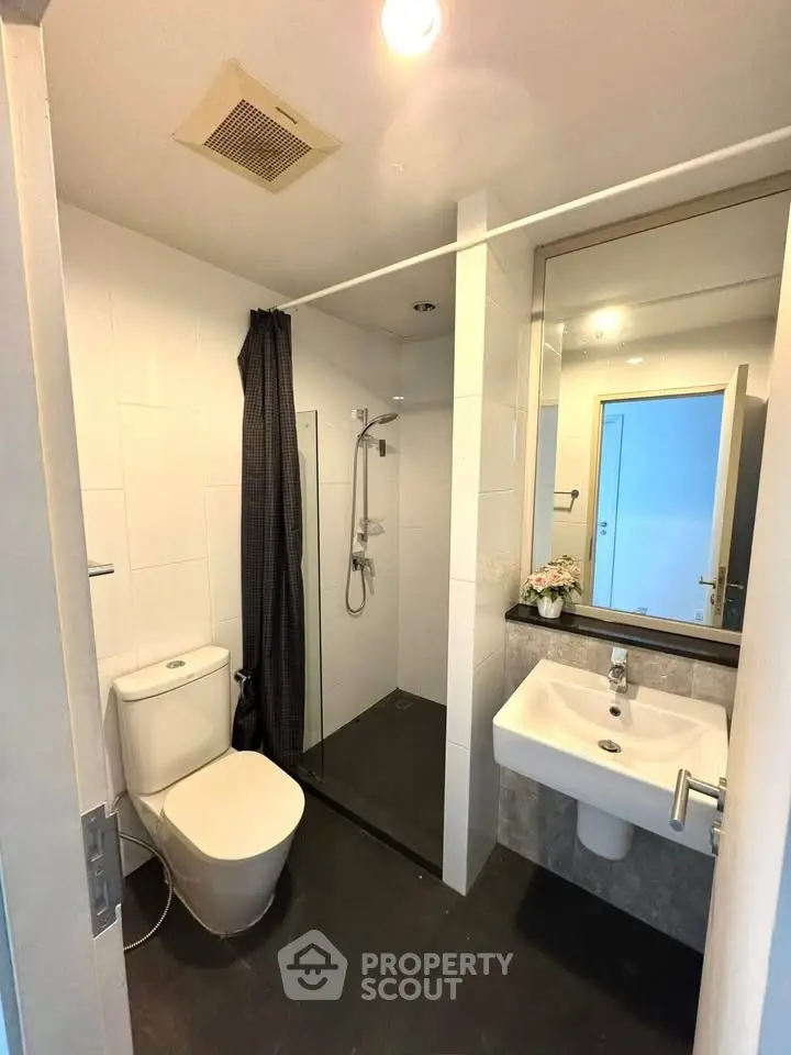 Modern bathroom with sleek fixtures and glass shower enclosure