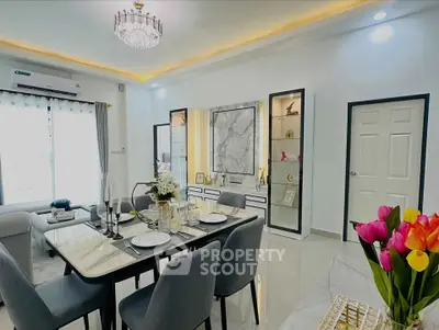 Elegant modern living and dining area with marble accents and chic decor