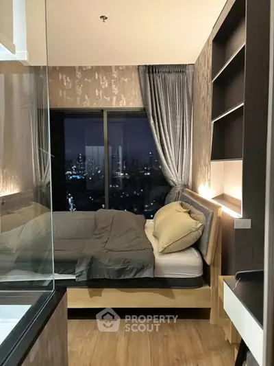 Modern bedroom with city view, featuring elegant decor and cozy ambiance, perfect for urban living.