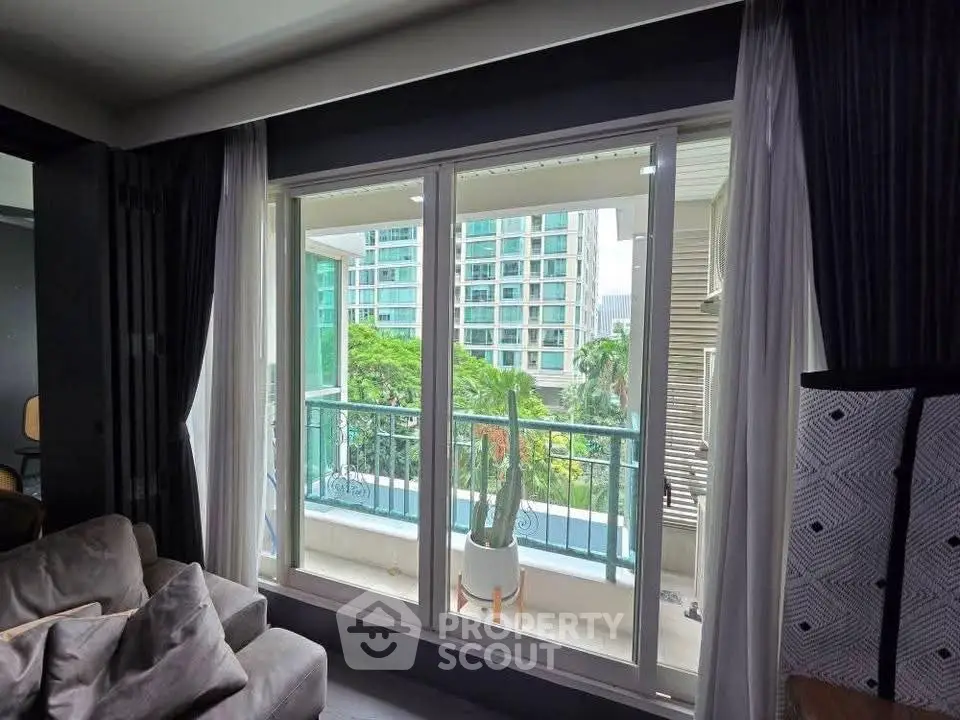 Spacious living room with balcony view in modern apartment