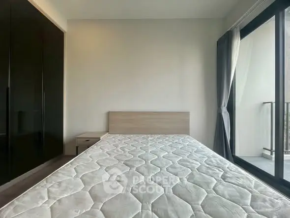 Modern bedroom with large window and minimalist design