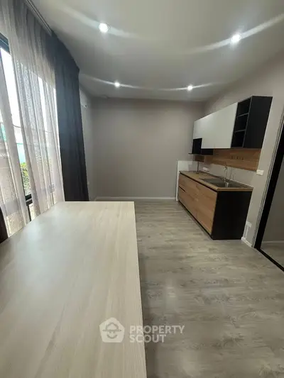 Modern kitchen with sleek cabinetry and ample natural light, perfect for culinary enthusiasts.
