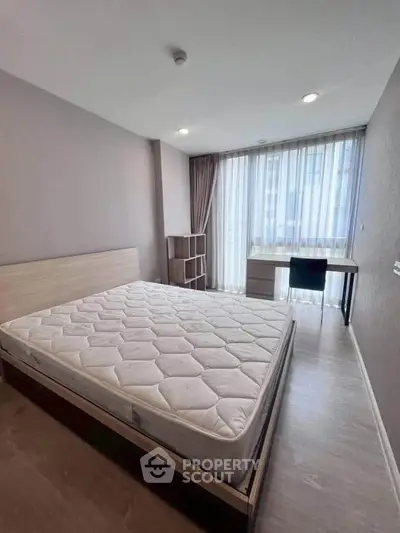 Modern bedroom with large window and minimalist furniture