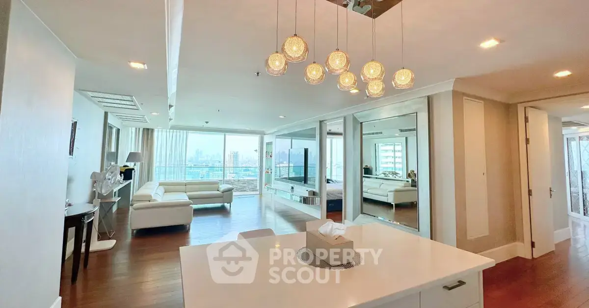 Spacious modern living room with elegant lighting and panoramic city view.