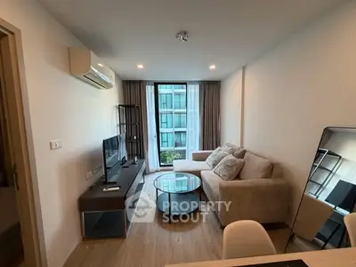 Modern living room with cozy sofa and large window view in stylish apartment.