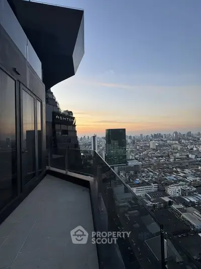 Stunning high-rise balcony with panoramic city skyline view at sunset.