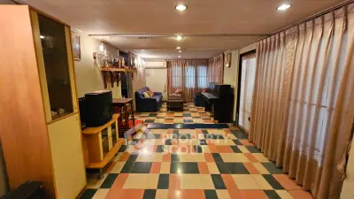 Spacious living room with colorful tiled floor and cozy seating area
