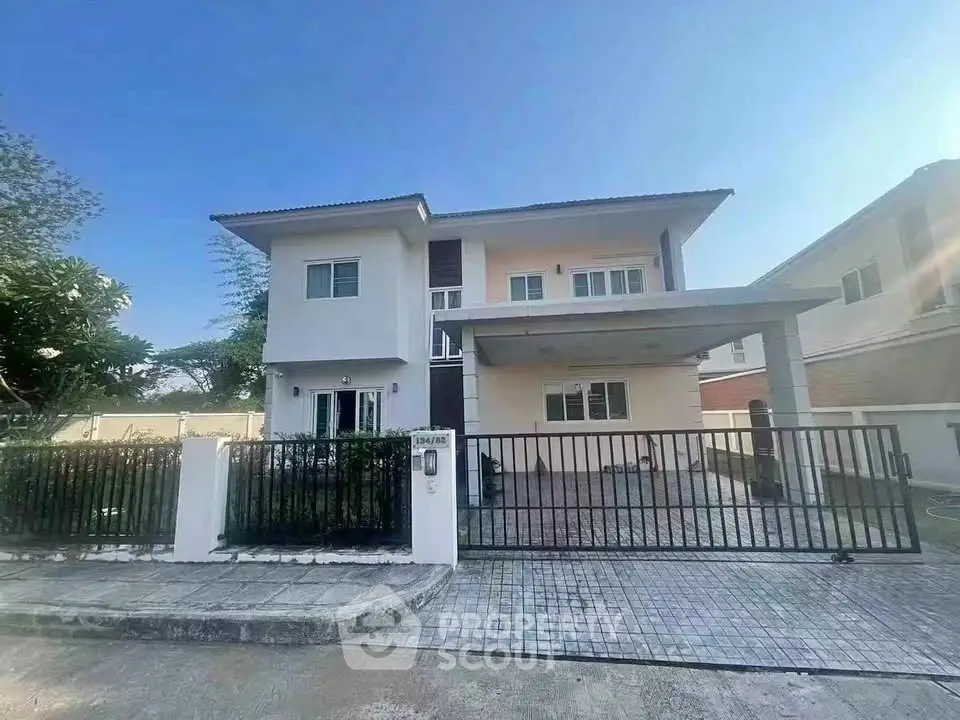 Modern two-story house with gated driveway and spacious exterior, perfect for family living.