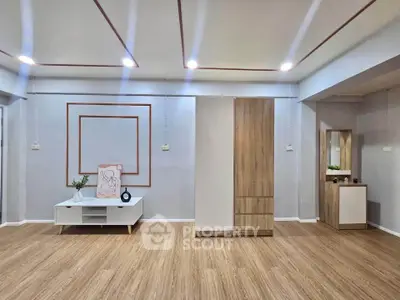 Spacious modern living room with elegant wood flooring and stylish furniture