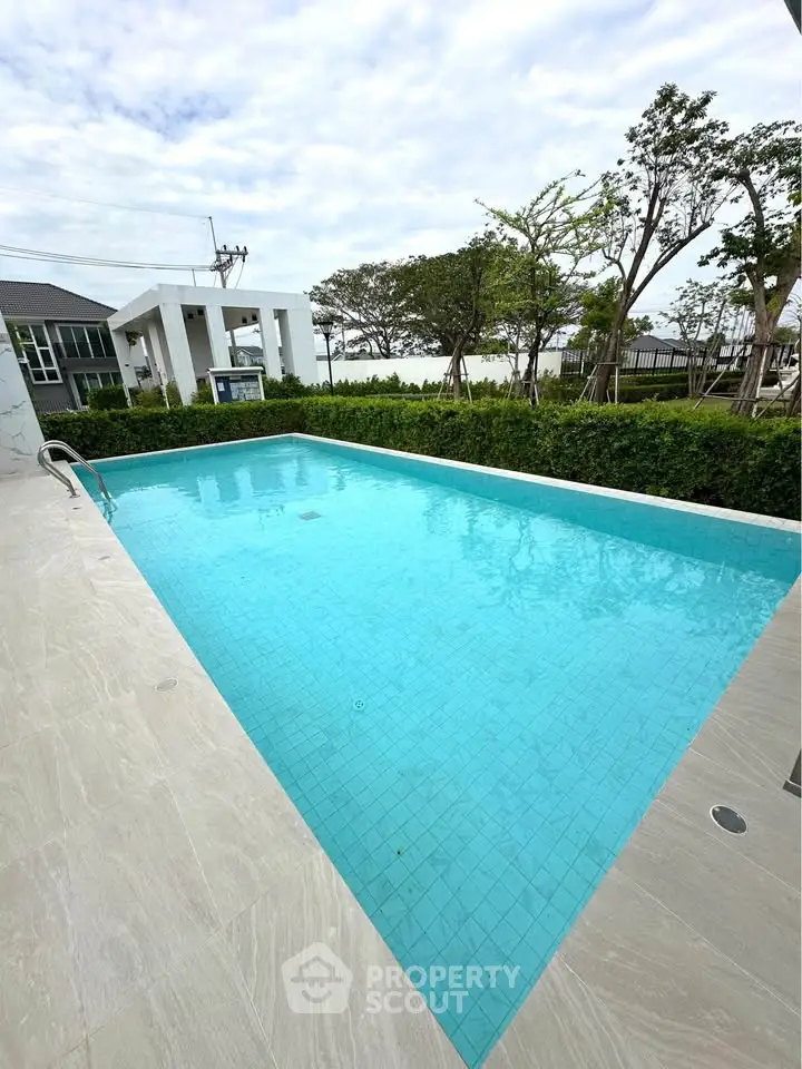 Luxurious outdoor pool with serene surroundings and modern design