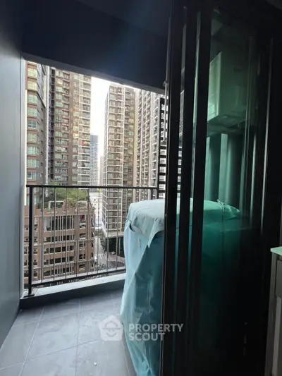 Modern balcony with city view in high-rise apartment, perfect for urban living.