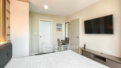 Modern bedroom with wall-mounted TV and minimalist decor