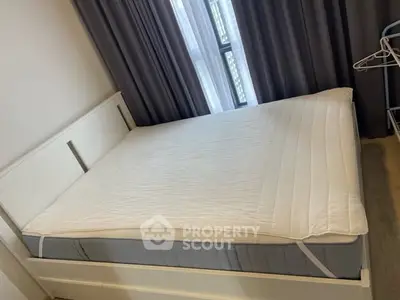 Cozy bedroom with a neatly made bed and modern curtains