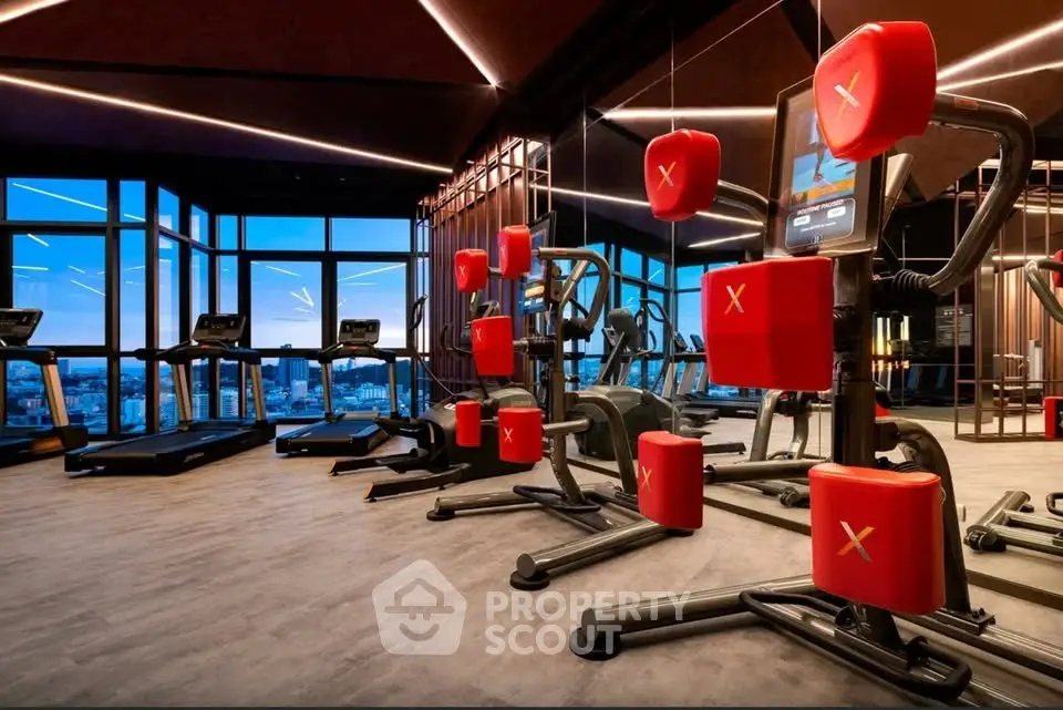 Luxurious gym with modern equipment and panoramic city views in upscale residential building.