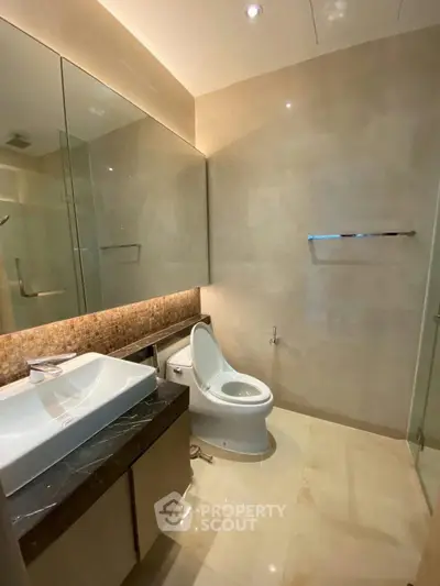 Modern bathroom with sleek fixtures and elegant lighting