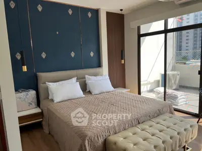 Luxurious bedroom with elegant decor and balcony access in modern apartment