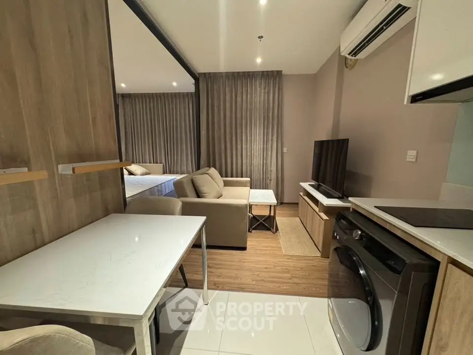 Modern studio apartment with open layout, featuring a cozy living area, sleek kitchen, and comfortable bedroom.