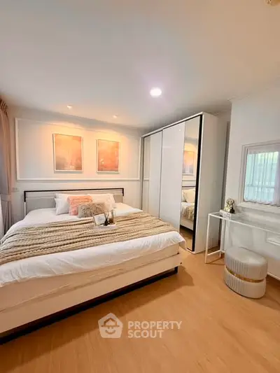 Cozy bedroom with modern decor and ample natural light