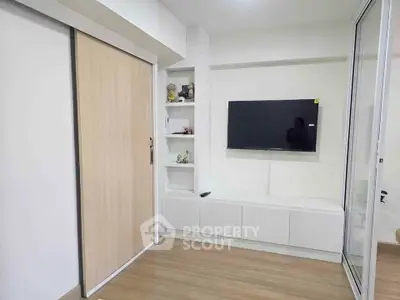 Modern living room with sleek TV setup and built-in storage