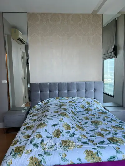 Luxurious bedroom with elegant decor and stunning city view, featuring a plush bed and modern furnishings.