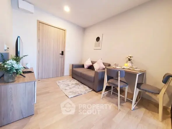 Modern living room with cozy sofa, dining table, and stylish decor in a bright apartment.