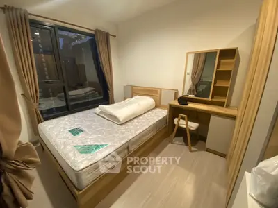 Cozy bedroom with modern furniture and large window in urban apartment