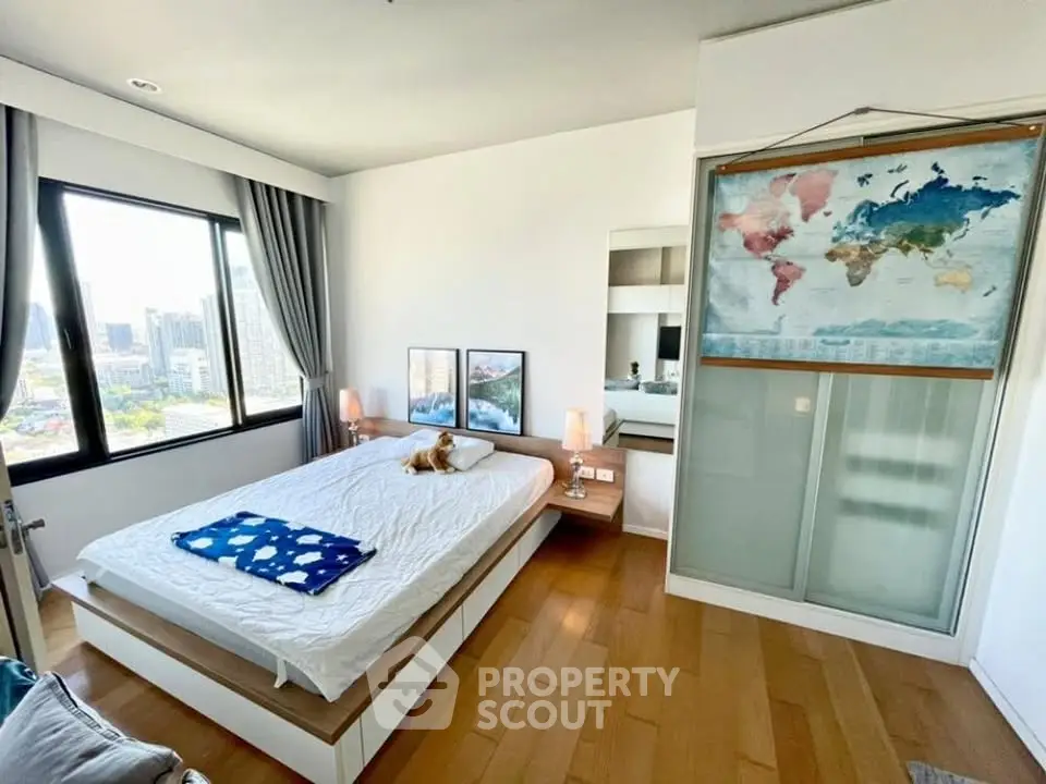 Modern bedroom with city view, wooden flooring, and stylish decor