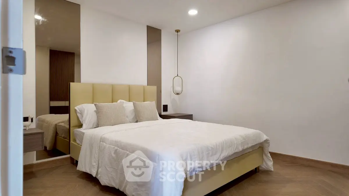 Modern bedroom with stylish decor and cozy ambiance, featuring a comfortable bed and elegant lighting.