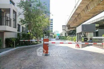 Modern building entrance with security gate and urban surroundings