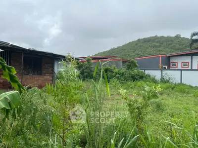 Lush green garden with scenic hill view and modern building exterior