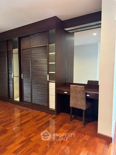 Elegant bedroom with wooden flooring and built-in wardrobe