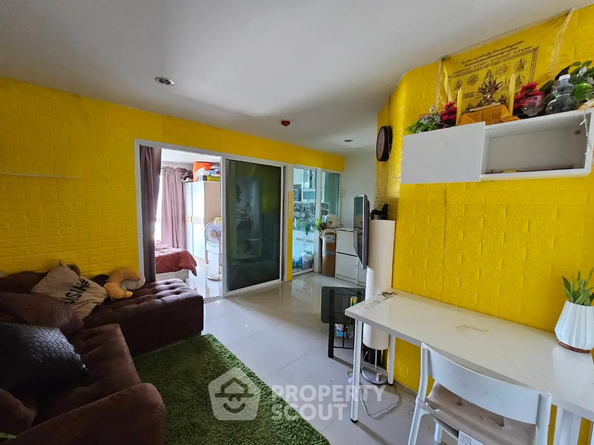 Charming living room with vibrant yellow walls and cozy furnishings