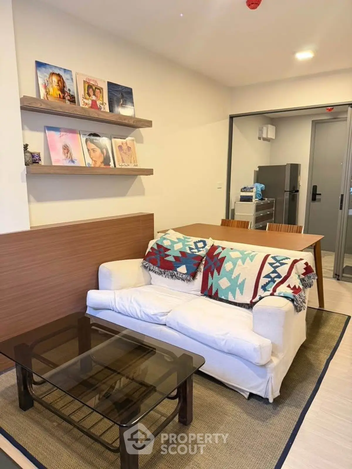 Cozy living room with modern decor and open kitchen layout in a stylish apartment.