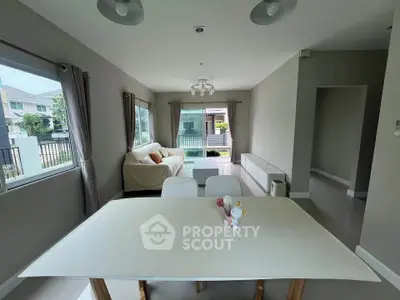 Spacious modern living room with dining area and large windows