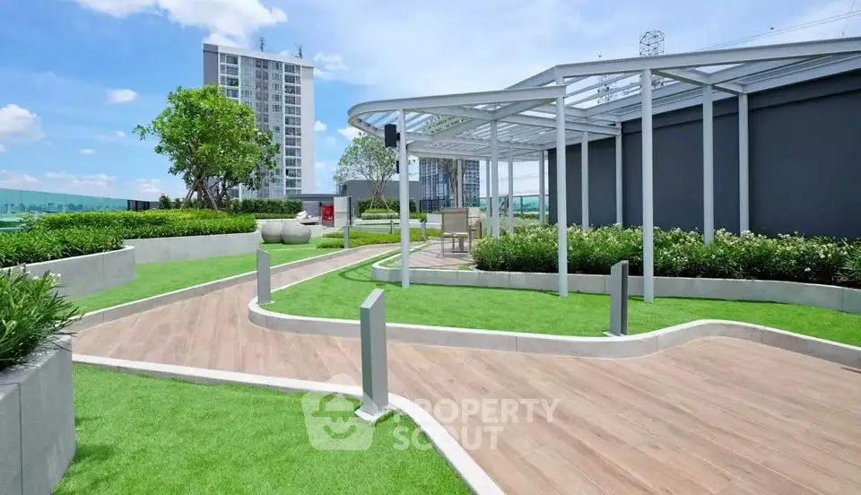 Modern rooftop garden with lush greenery and stylish pathways in urban setting.