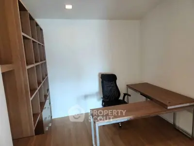 Modern study room with sleek wooden desk and ergonomic chair, perfect for productivity.