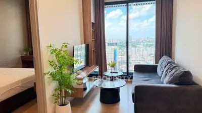 Modern living room with city view, cozy sofa, and stylish decor in high-rise apartment.