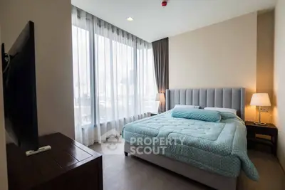 Modern bedroom with large windows and stylish decor in urban apartment