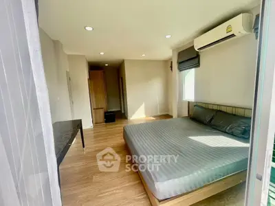Spacious bedroom with modern design and ample natural light